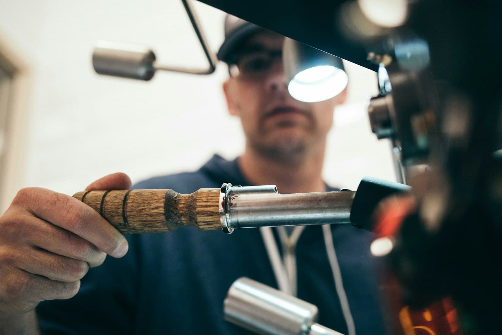 A Tolano's locksmith cutting a key on a machine, close and focused on the work